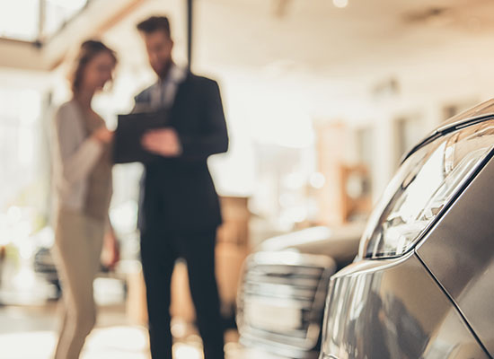 Sales person hands keys over to client